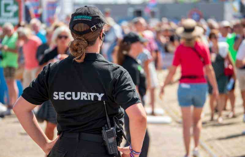 a-woman-in-a-security-uniform-at-an-event a-woman-in-a-security-uniform-at-an-event